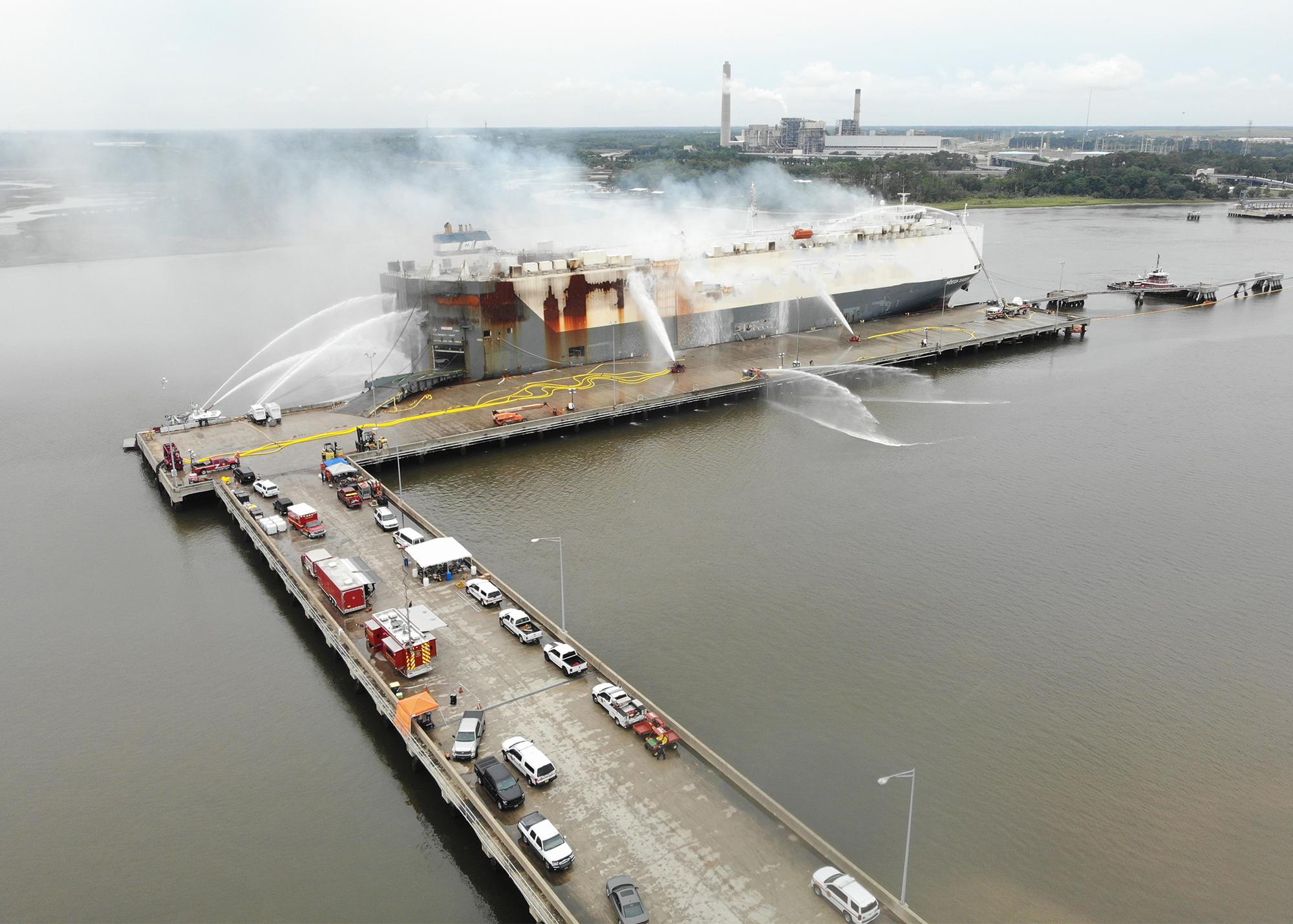Aerial view of fireboats spraying a car carrier during the Jacksonville response